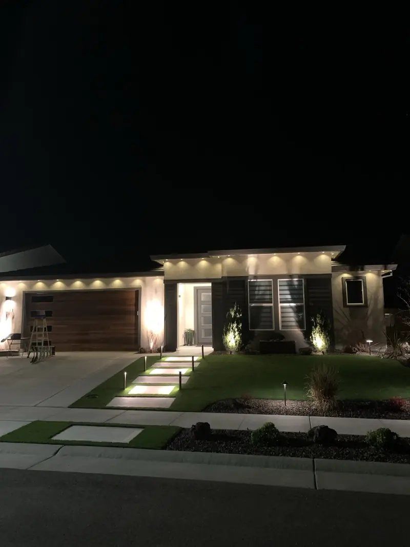 Modern single-story home with warm white roofline lights
